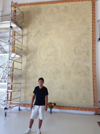 Tashi Dhargyal stands before his Thangbochi (big thangka). Drawing has just been completed. Painting will occupy Tashi for the next five years.